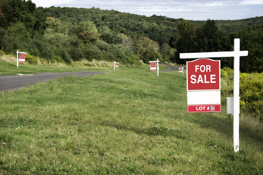 Vacant lot with for sale sign